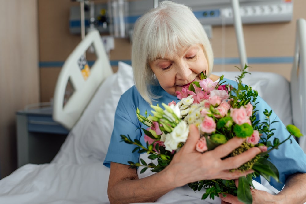Woman With Floral Bouquet In Hospital