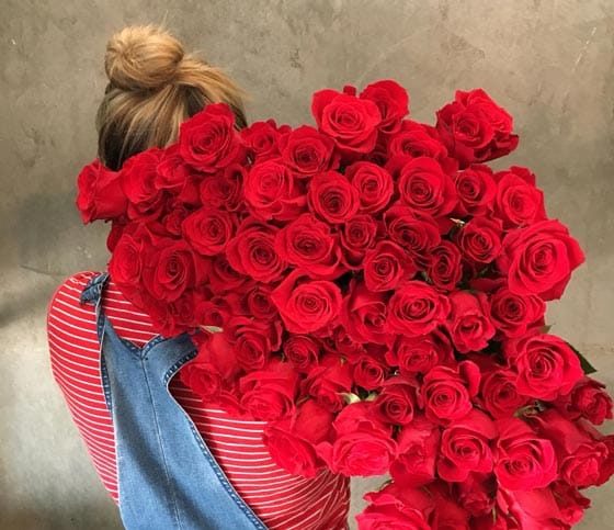 Woman Holding Large Bouquet Of Roses — Florist in Birtinya, QLD