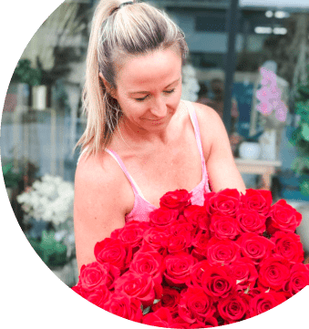 Florist Holding Large Bouquet Of Red Roses — Florist in Birtinya, QLD