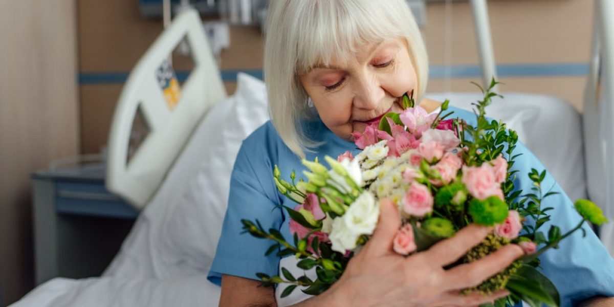 Woman With Floral Bouquet In Hospital